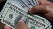 El dólar oficial baja y se cotiza en 12,05; ya rige la nueva fórmula para fijar precio