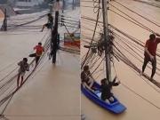 Caminaron sobre cables eléctricos para salvarse de las inundaciones que azotan Tailandia: el video